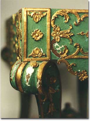 Detailed view, condition before restoration: missing ornamentation, damaged areas in the gilded sections and painted surface. Visible: the original polychrome surface of the little table: turquoise green